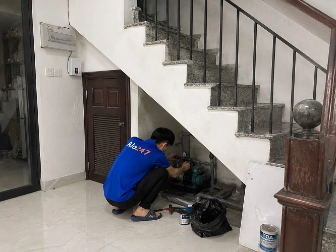Thợ alo247 đang sửa máy bơm tại Mê Linh